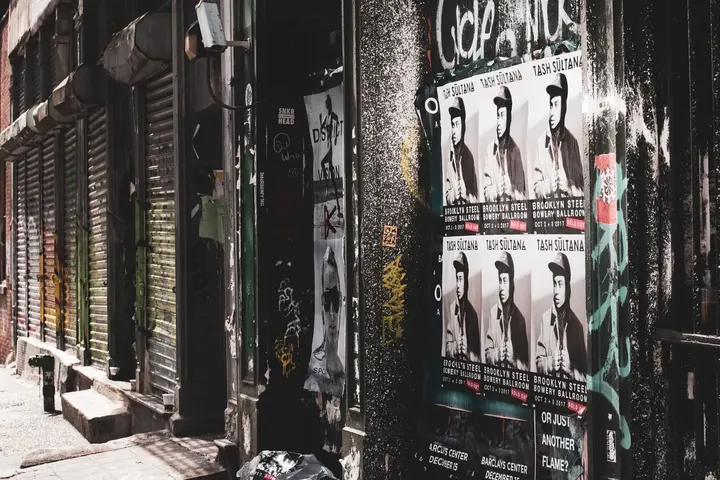 Wall covered in layered gig and event posters